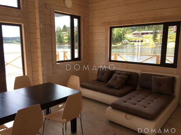 Проект деревянного дома из клееного бруса с крытой террасой расположенной по всему периметру дома