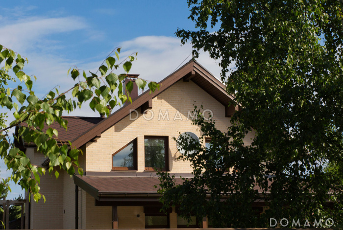 Проект дома из пеноблоков с угловой террасой и просторным балконом на мансардном этаже